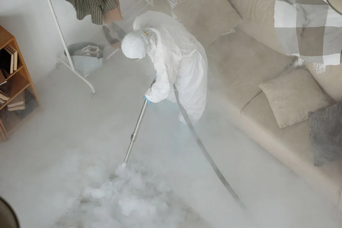 Biohazard cleanup technician in protective equipment, La Pryor, TX